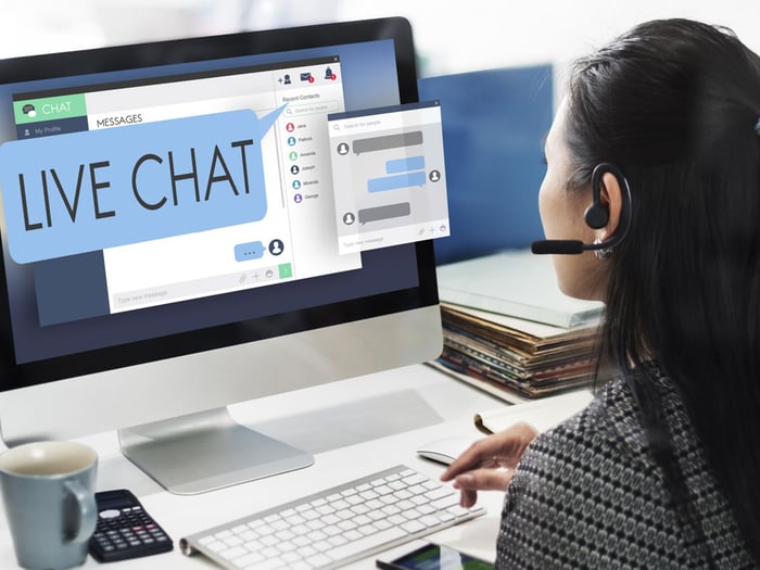 Person-monitoring-live-chat-and-delivering-real-time-customer-service