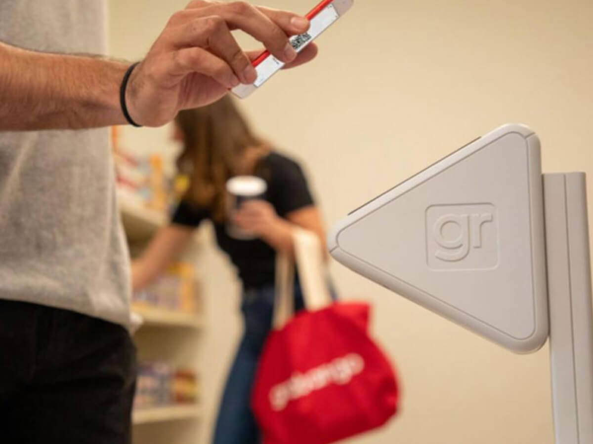 Person paying with a phone using Grabango technology.